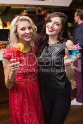 Pretty friends drinking a cocktail