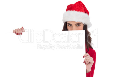Beauty brunette in santa hat showing white poster
