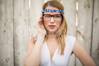 Portrait of a blonde woman wearing glasses and headband