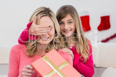 Little girl hiding gift from mother