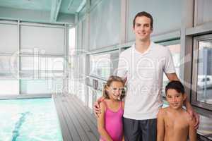 Swimming coach with his students