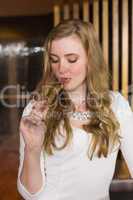 Pretty blonde sipping glass of champagne