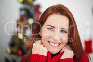 Festive redhead smiling at christmas