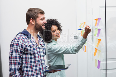 Team looking at sticky notes on window