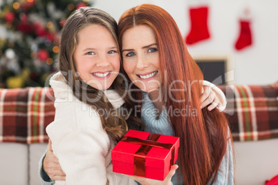 Daughter giving her mother a christmas present