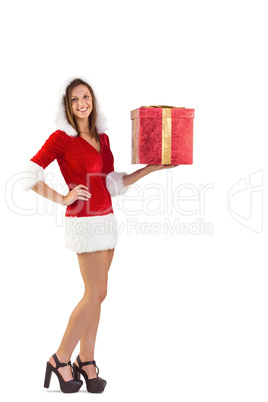 Pretty santa girl holding gift