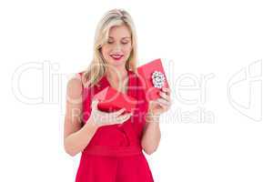 Stylish blonde in red dress opening gift box