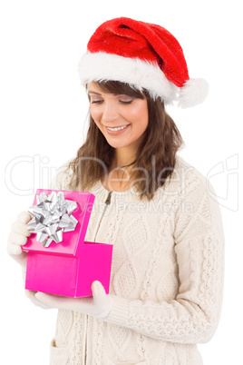 Smiling brunette opening christmas gift