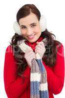 Happy brunette in winter clothes smiling at camera