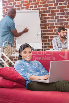 Casual woman using laptop on couch