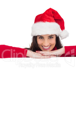 Beauty brunette in santa hat smiling at camera