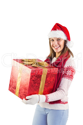 Young woman in stylish warm clothing holding a gift