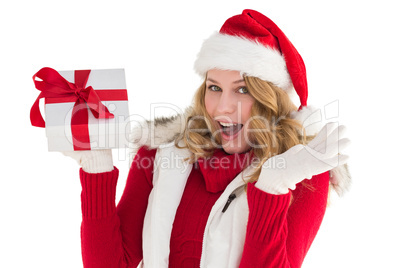 Excited blonde in santa hat holding gift