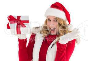 Excited blonde in santa hat holding gift