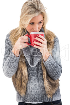 Woman in winter clothes holding a mug