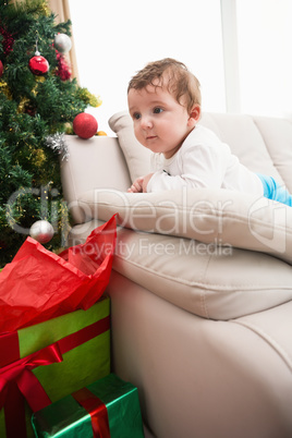 Cute baby boy on couch at christmas