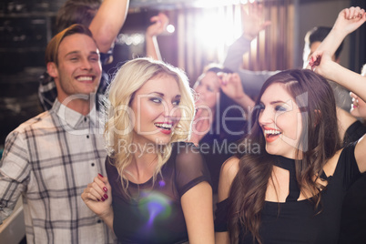 Stylish friends dancing and smiling