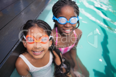 Cute little kids sitting poolside