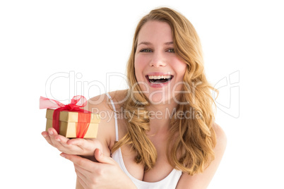 Smiling young woman holding a small gift