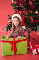 Festive little girl sitting in large gift