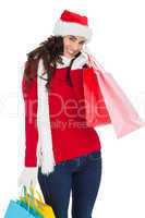 Happy brunette in winter wear holding shopping bags
