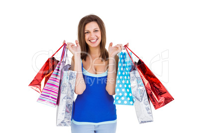 Smiling brunette woman holding shopping bags