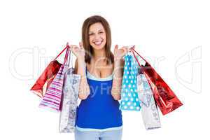 Smiling brunette woman holding shopping bags