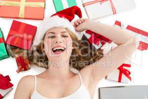 Smiling woman laying on the floor with gifts around her
