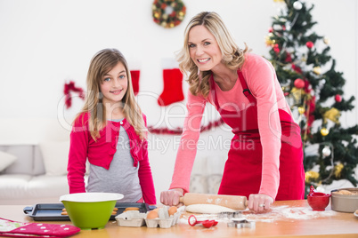 Festive mother and daughter making christmas cookies