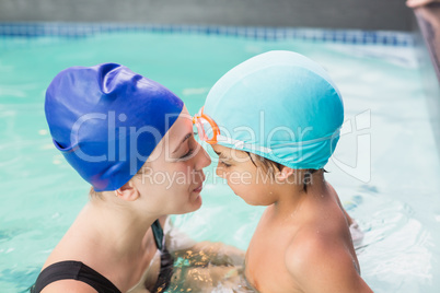 Happy mother and son in the swimming pool