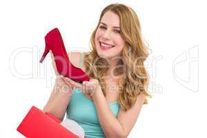 Elegant brunette admiring a shoe