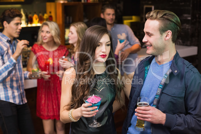 Happy friends having a drink together