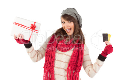 Brunette in winter clothes holding gift