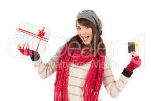 Brunette in winter clothes holding gift