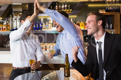 Handsome friends having a drink together