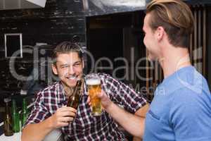 Young men drinking beer together