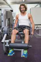 Handsome man doing leg workout at gym