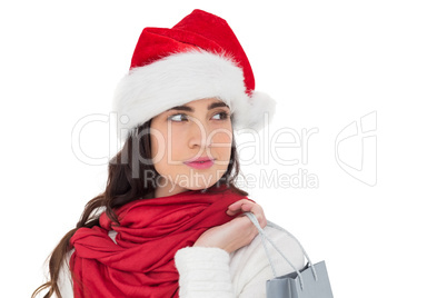 Brunette in santa hat holding shopping bag