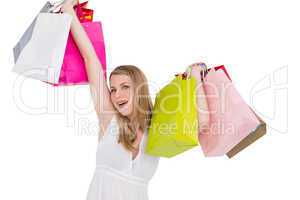 Blonde woman raising shopping bags