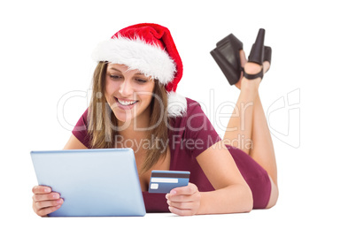 Festive brunette shopping online with tablet