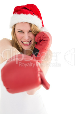 Festive blonde punching with boxing gloves