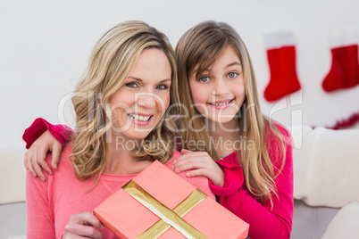 Festive mother and daughter smiling at camera