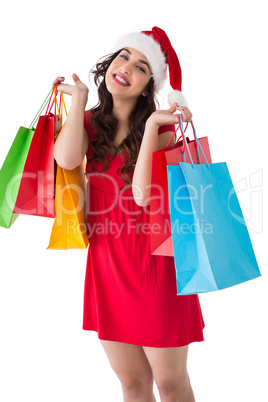 Festive brunette holding shopping bags