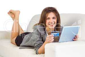 Woman doing online shopping with tablet and credit card