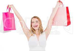 Young woman holding up shopping bags