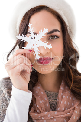 Pretty brunette holding a snowflake