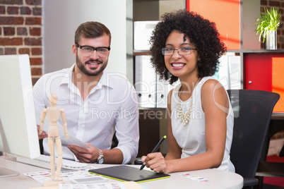 Smiling photo editors in office