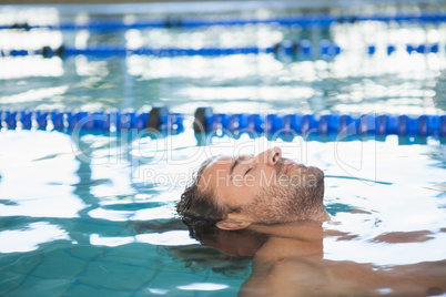 Close-up side view of a fit swimmer in the pool