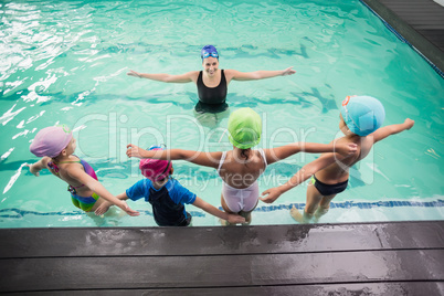 Cute swimming class watching the coach