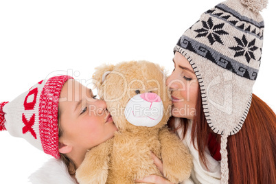 Mother and daughter holding teddy bear